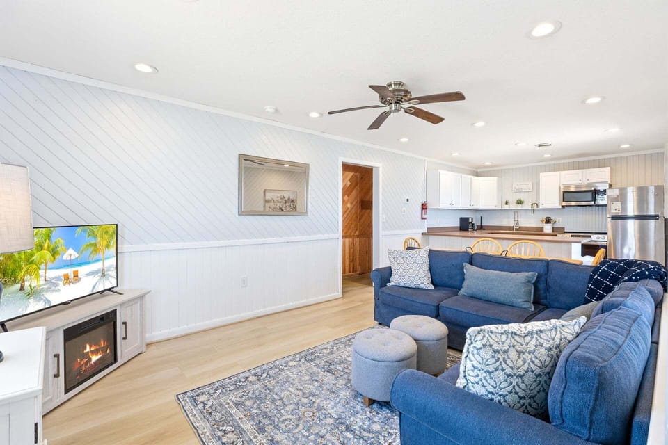 Living Area: Relax in the cozy living room with classic beach cottage charm and a flat-screen TV.
