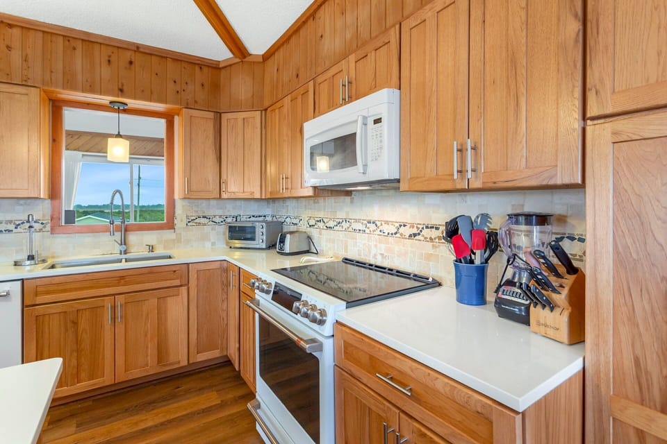 Kitchen: Cook with ease in the fully equipped kitchen featuring granite counters, hickory cabinets, and modern appliances.