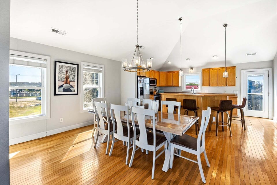 The spacious dining table comfortably seats eight guests for shared meals.