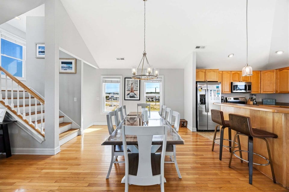 The spacious dining table comfortably seats eight guests for shared meals.