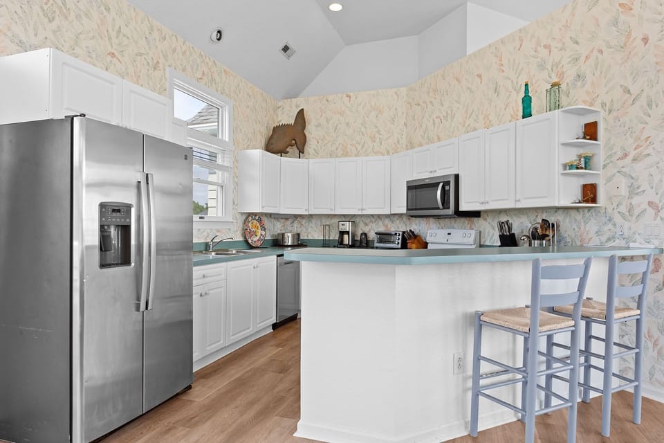 The modern kitchen is fully equipped for preparing breakfast, dinner, or casual snacks during your vacation.