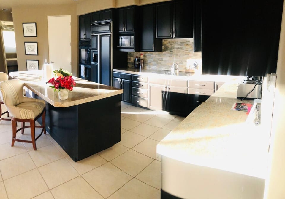 This is a gourmet kitchen, with beautiful pots, pans, dishes for the chef.