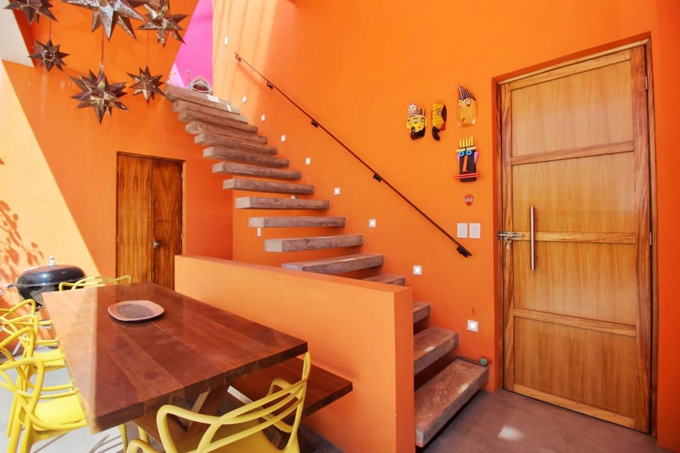 Front door, dining table for 8 people and stairs to the second level and roof-top.