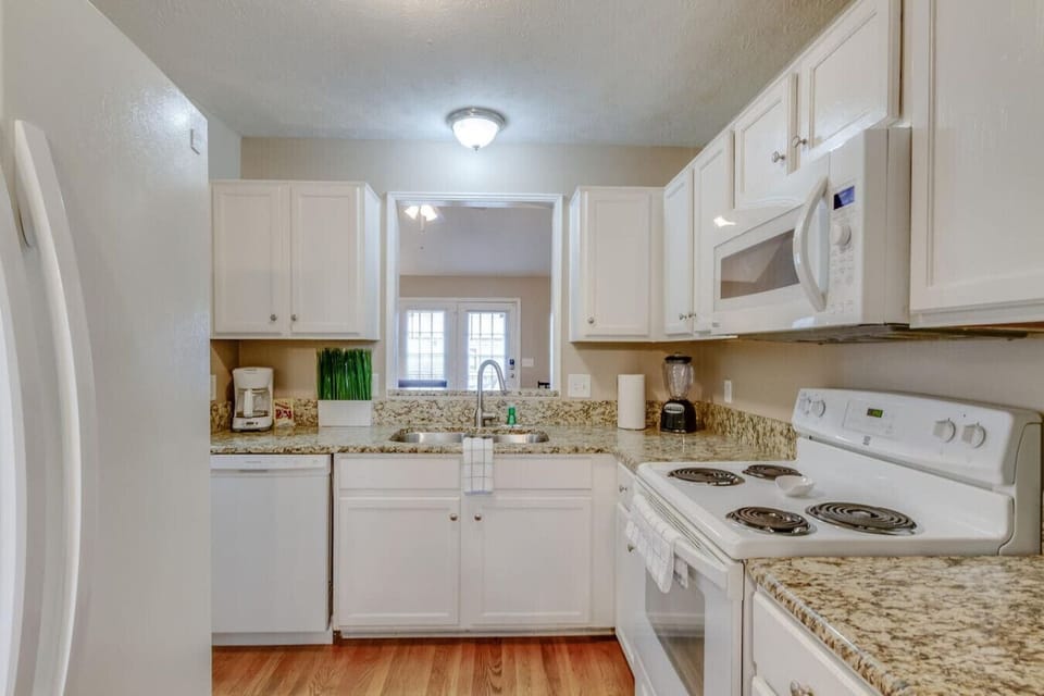 A well-equipped kitchen with granite counters and natural light.