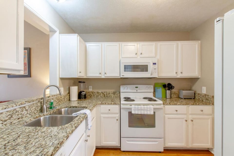 Cook with ease in the fully equipped kitchen with granite counters.