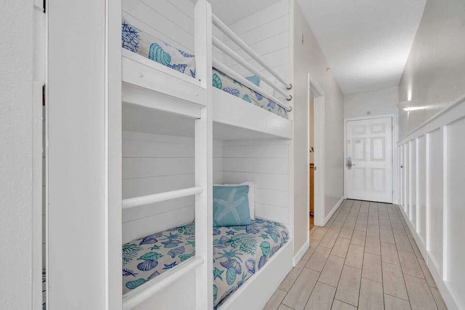 Cozy built-in bunk beds with ocean-themed bedding create your perfect hideaway for restful nights.