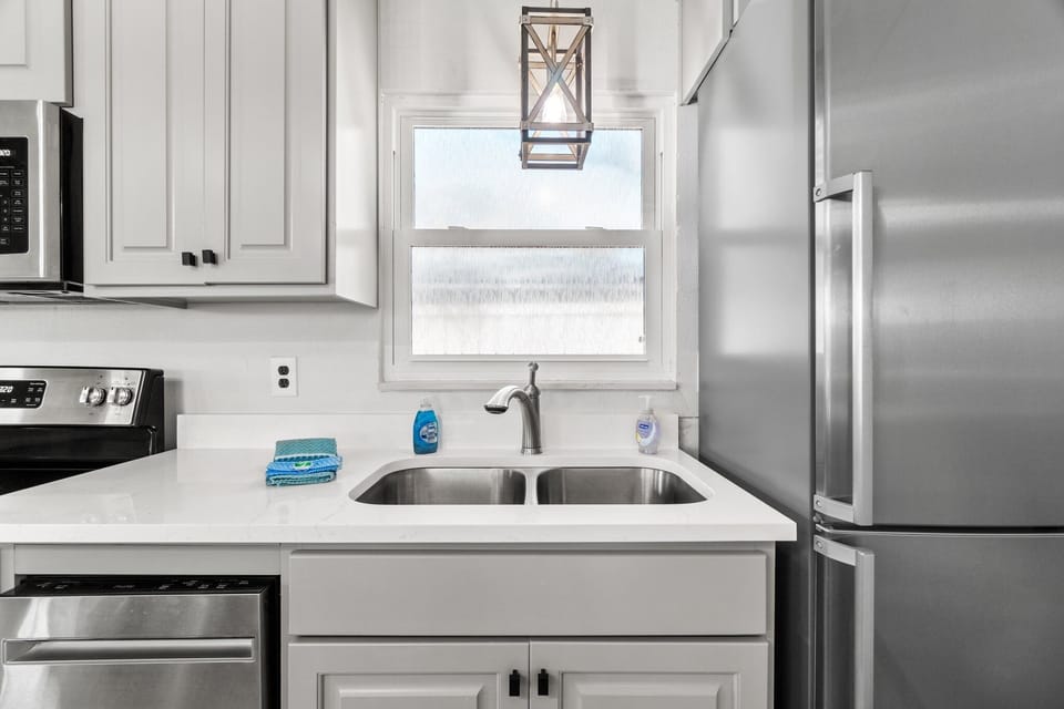 Kitchen Sink, dishwasher, and fridge.