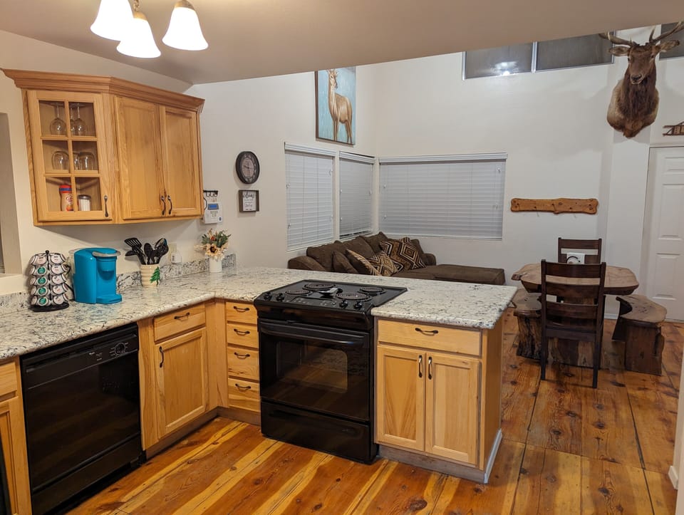 Kitchen is stocked with dishes, basic cooking tools, and single-serve coffee.