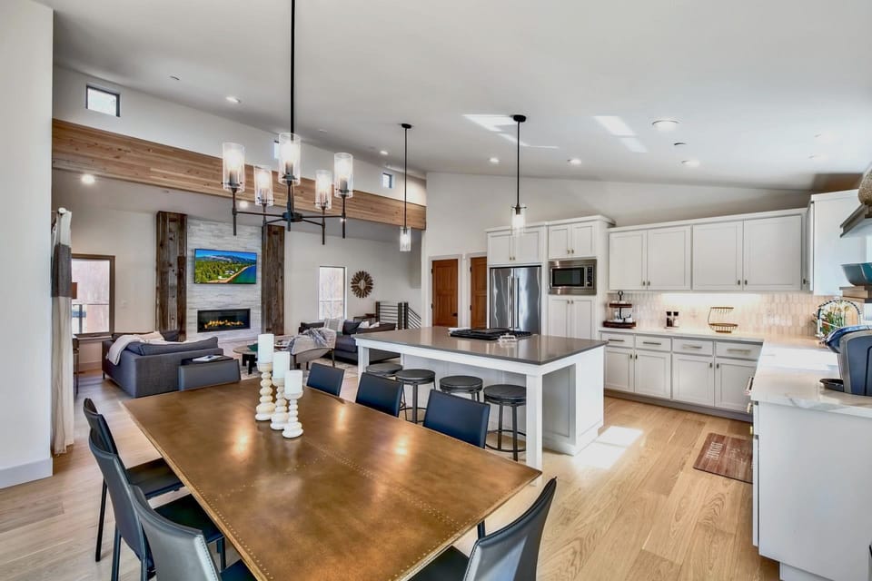 A stunning open-concept kitchen and dining space with custom shaker cabinetry, quartz counters, and stainless steel appliances. Designed for both functionality and stylish gatherings.