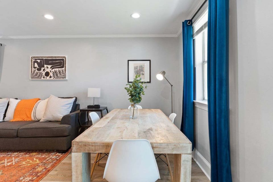 Sunlit dining area w/ four seats — ideal for sharing meals together.
