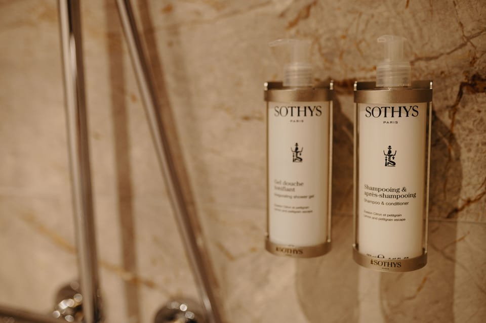 Shower, rainfall showerhead, hair dryer, towels