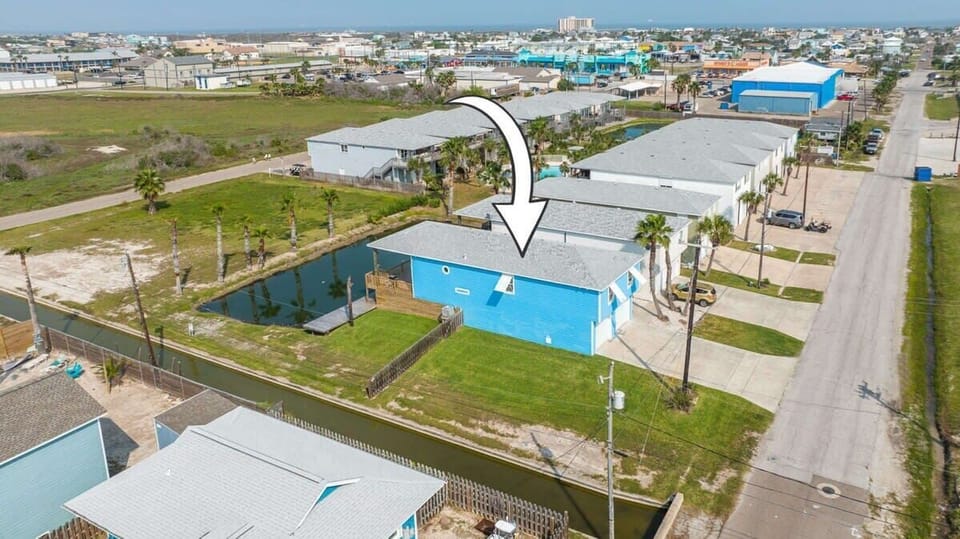Aerial View — Blue Beach House with Pond & Palm Trees