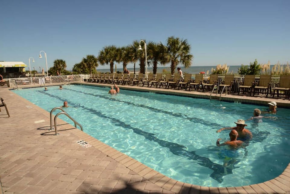 Take a cool dip in the sparkling pool after a fun day at the beach.