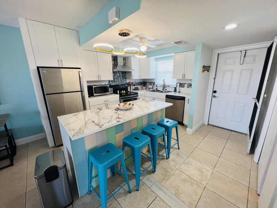 The guest room with pocket doors is located directly across from the island.  