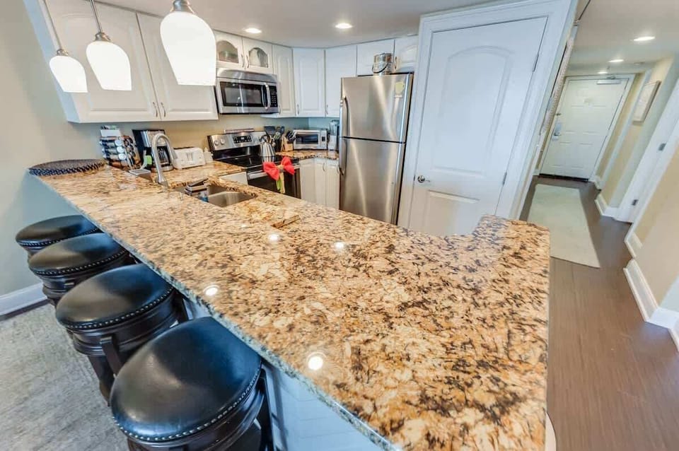 - Bright and inviting kitchen with a full suite of stainless steel appliances - Large island with bar seating for four, ideal for entertaining or quick meals - Thoughtfully designed with plenty of storage and stylish lighting to enhance your stay
