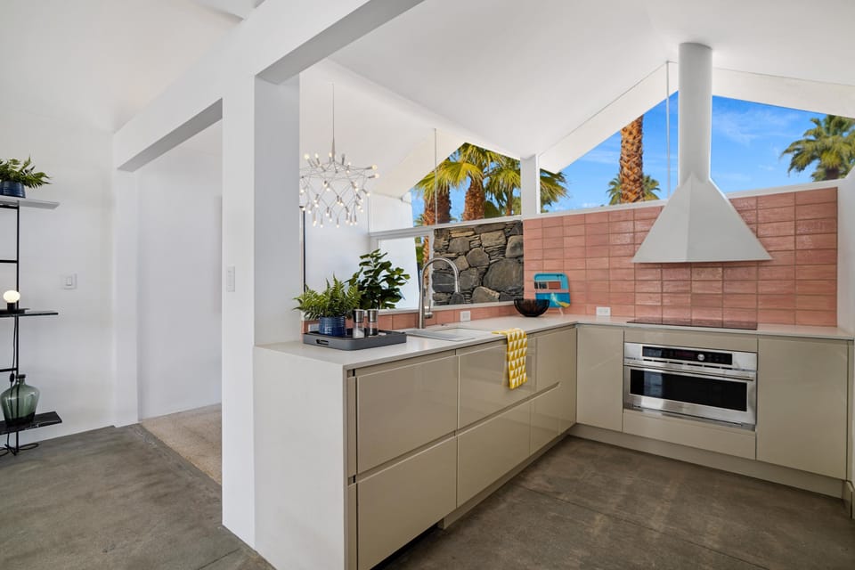 The kitchen is silky, shiny, and polished. As you can see, mid-century elements are represented all over. 