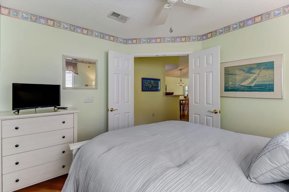 Full size bedroom with view to hall / kitchen space