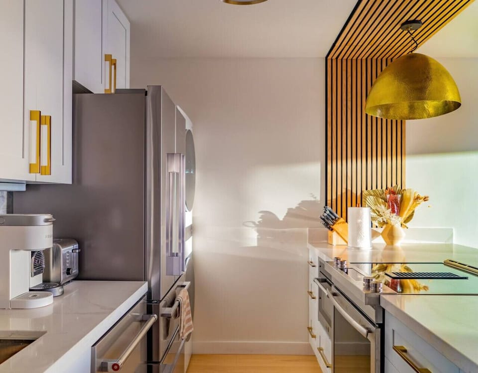 Fully equipped kitchen with luxury appliances. Oversized quartz island with seating for 3. Washer dryer.