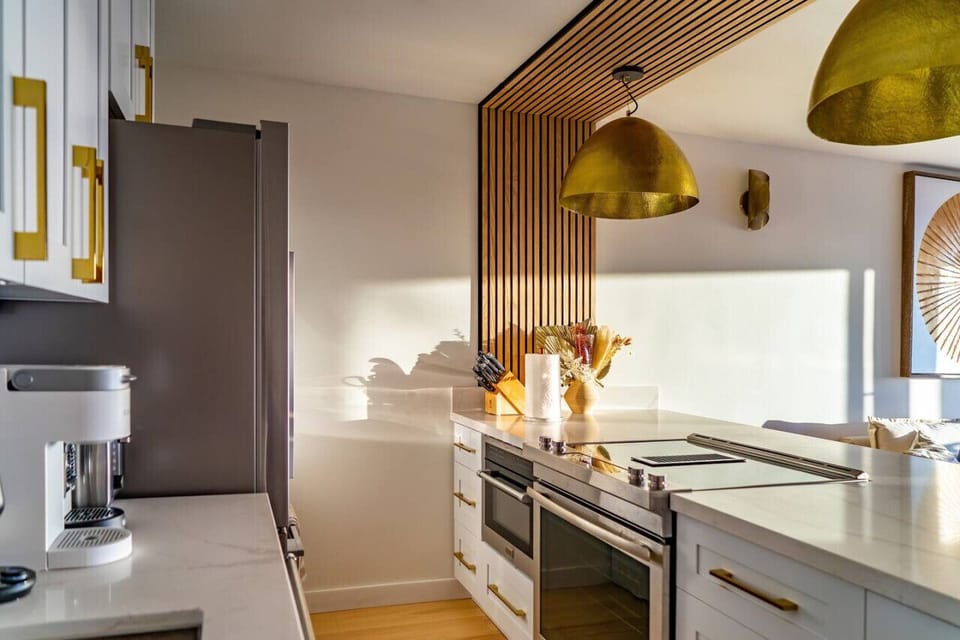 Fully equipped kitchen with luxury appliances. Oversized quartz island with seating for 3. Washer dryer.