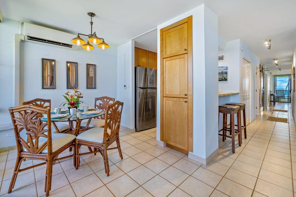 Gather for meals in this bright dining area with stylish tropical decor and natural light, offering a welcoming space for family and friends.