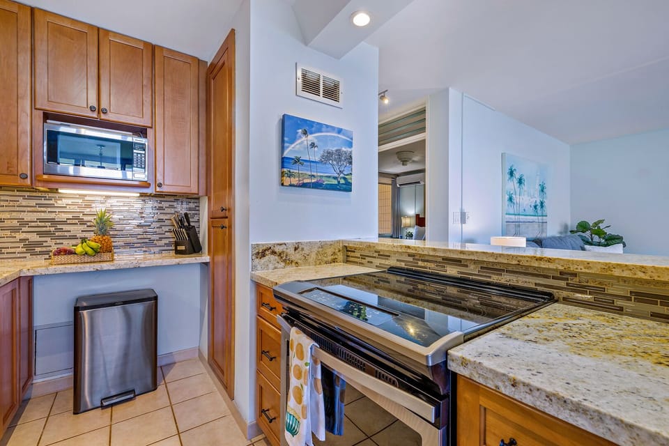This open-concept kitchen allows for a seamless cooking and dining experience while enjoying breathtaking island views just beyond the balcony.