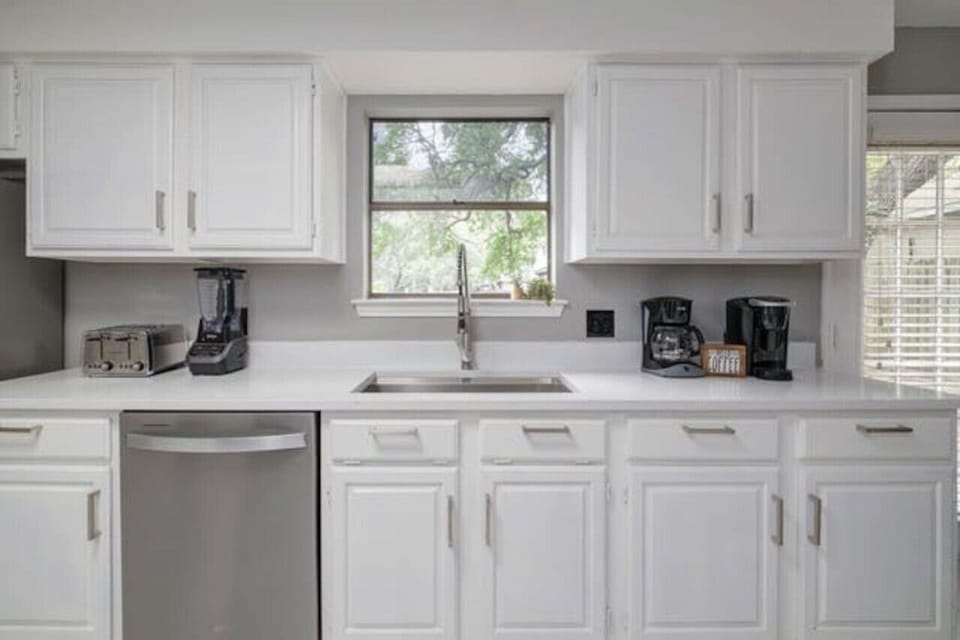 Bright, well-equipped kitchen at Boni and Blithe makes mornings easy with coffee, prep space, and natural light.