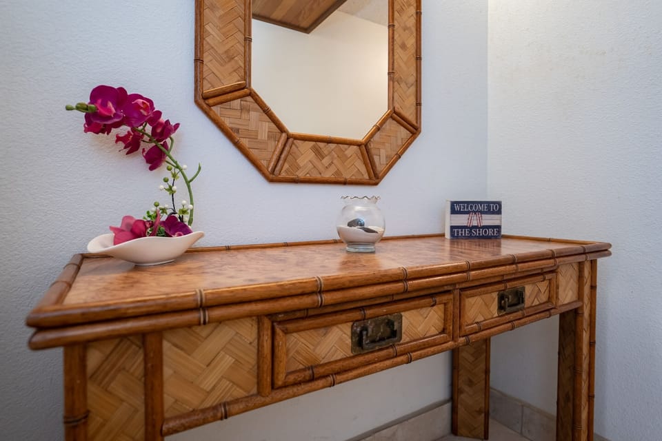 A charming tropical-inspired vanity area adds a touch of island character, providing a convenient space to get ready or unwind after a day of exploring Maui.