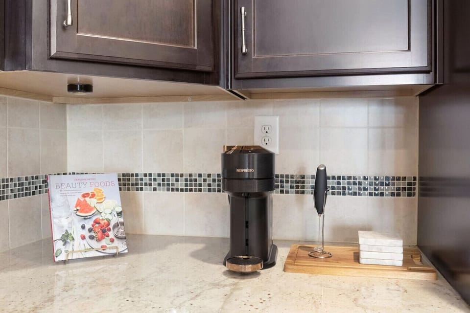 Indulge in a Nespresso delight and create luscious lattes with our handy milk frother. Savor these luxuries at our Cary, NC long-term rental, featuring modern design, lightning-fast Wi-Fi, and a plethora of workspaces. ☕🌟🏡💻