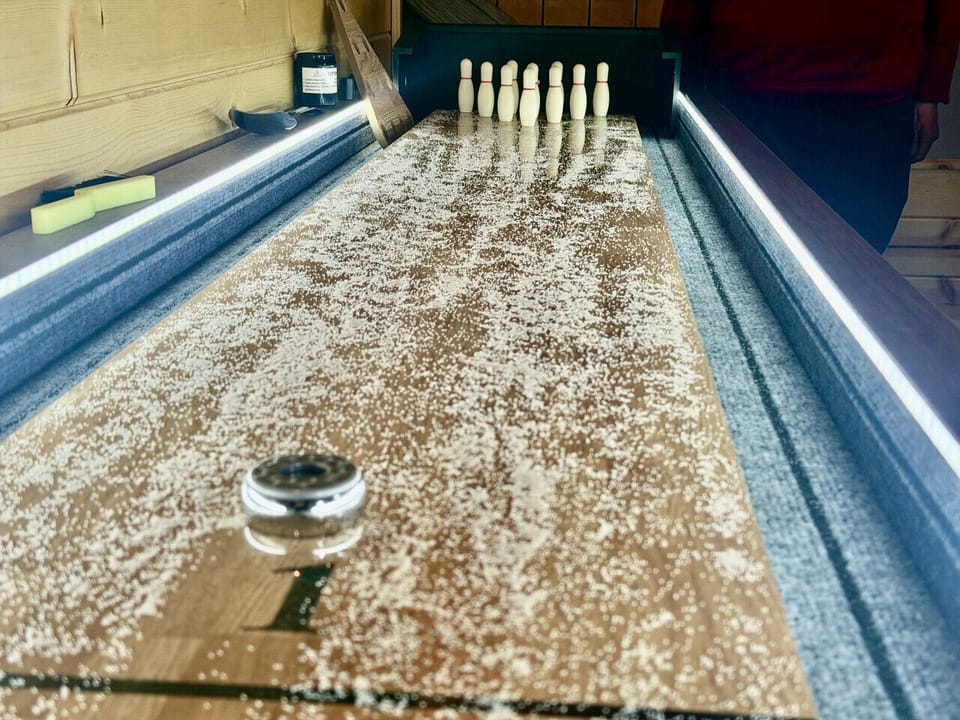 Addicting shuffleboard table with bonus bowling set