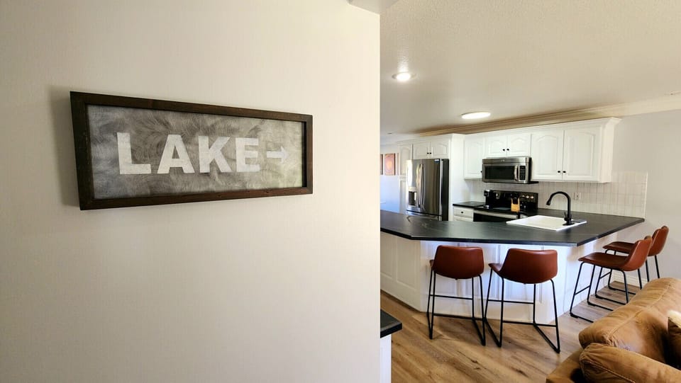 Inviting open kitchen with island seating, modern finishes, and cozy touches near the lake retreat