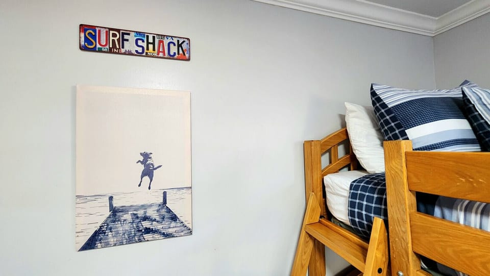Playful bunk room with cozy beds and beachy décor, perfect for kids and fun group stays
