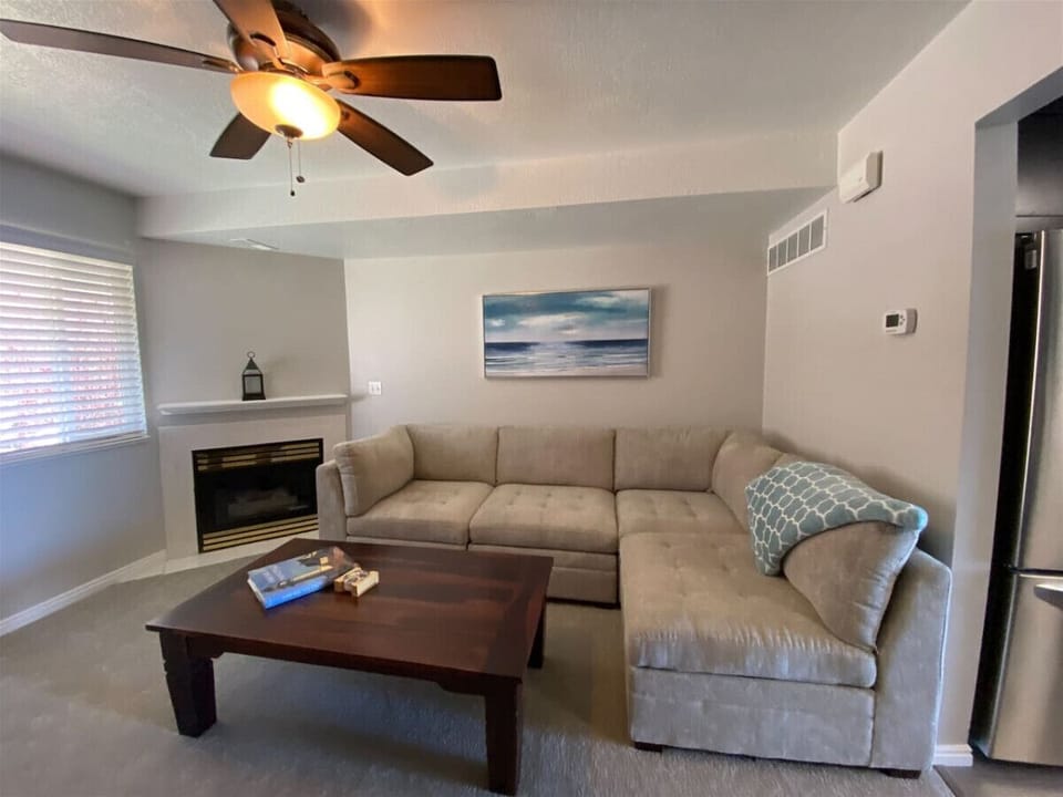 Cozy sectional and fireplace create the perfect gathering spot