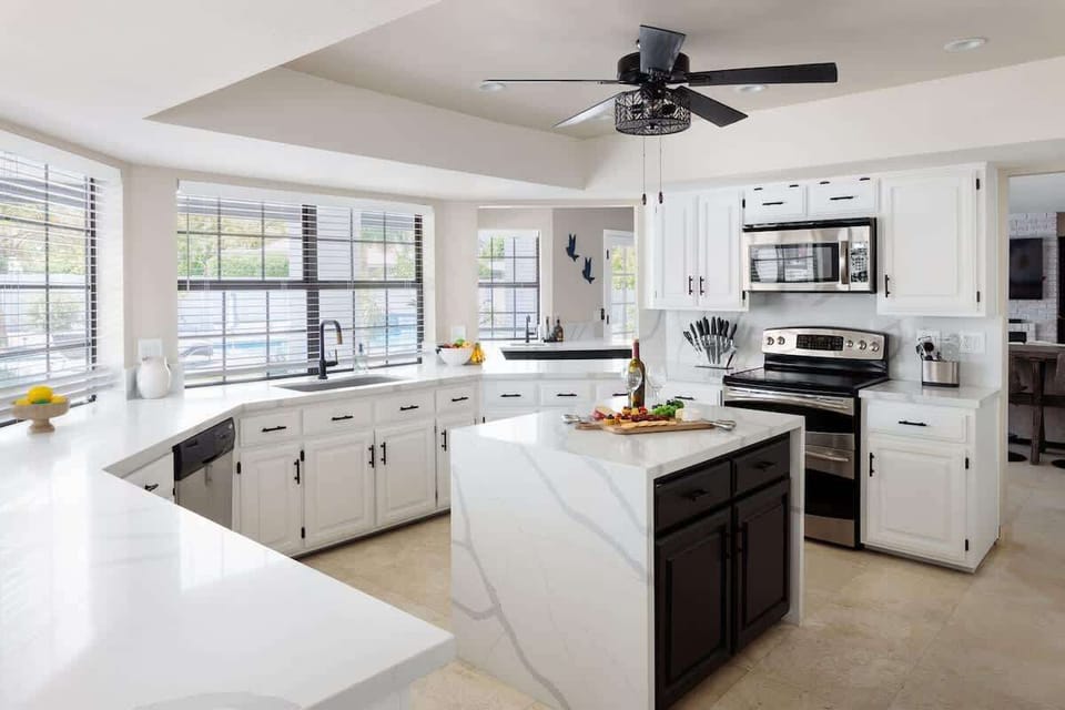 The fully equipped modern kitchen is stocked with all culinary essentials and stainless-steel appliances. (1st Floor)