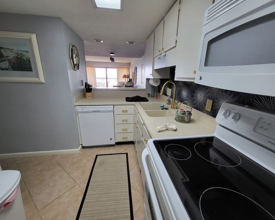 Well equipped kitchen open to living area with view