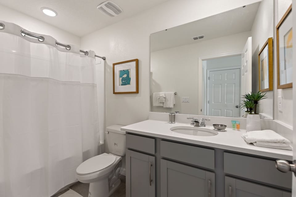 Adjacent bathroom with shower over bath