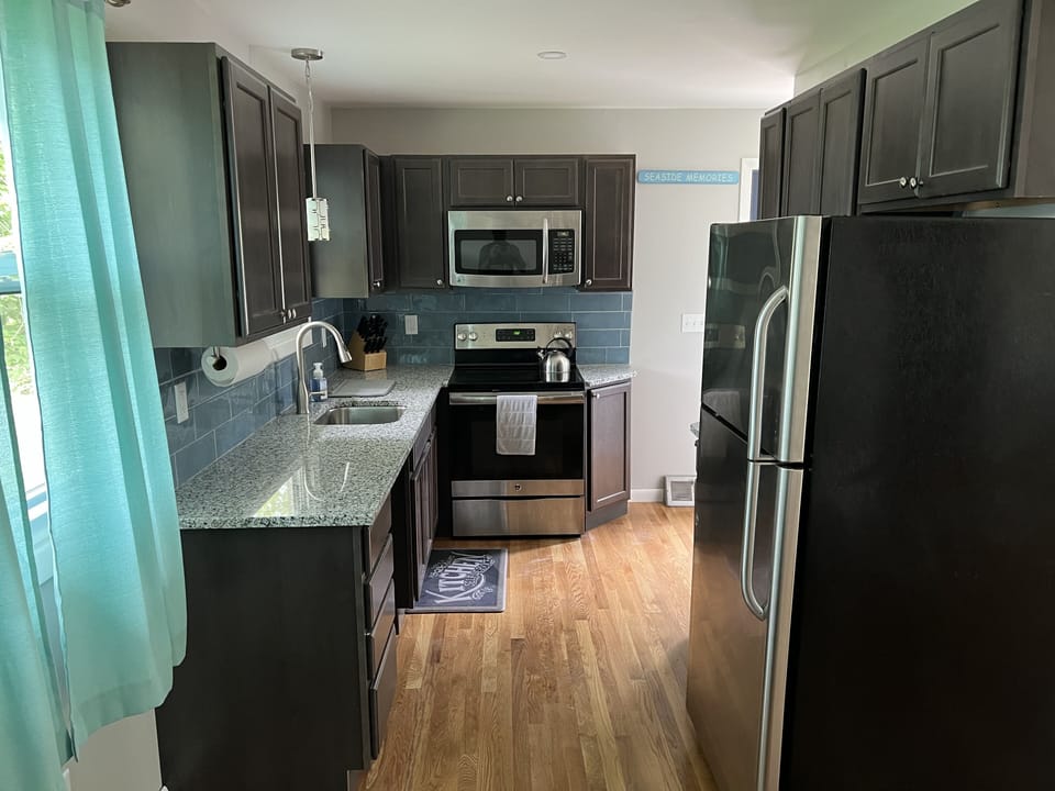 Newly renovated kitchen with granite countertops and all major appliances. 
