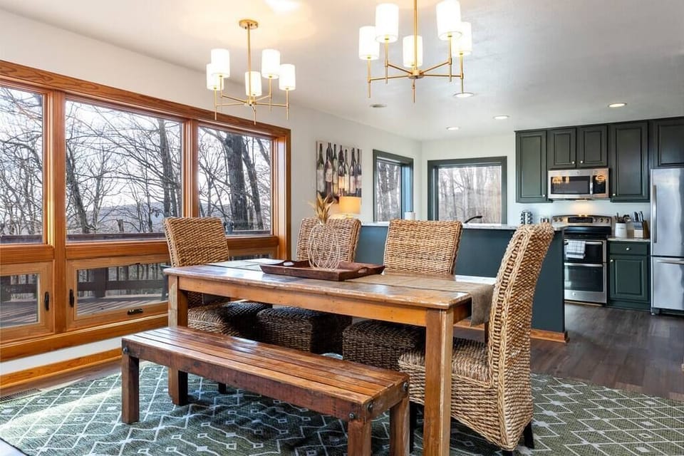 The open kitchen with a large dining table complete with mountain views.