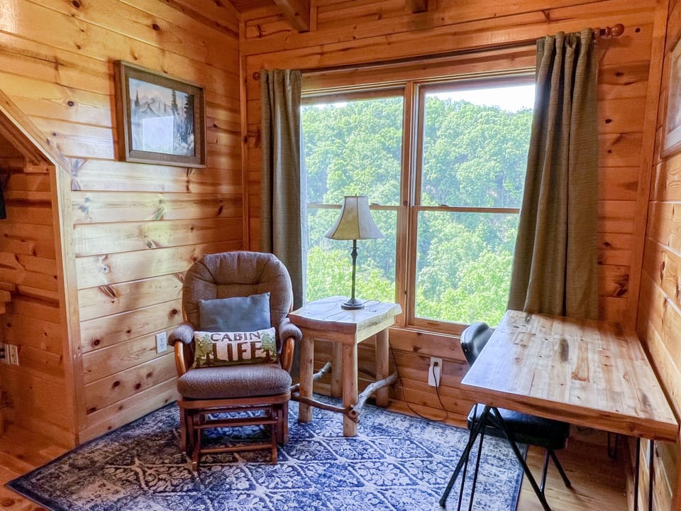 The top floor has a desk and rocking chair. 