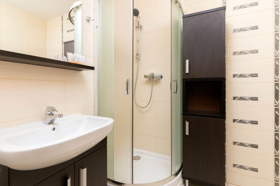 Bathroom with a sleek sink, mirror, and modern design in neutral tones.
