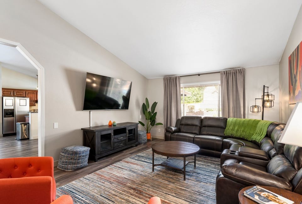 Comfortable newly furnished family room with 75 in Smart TV and reclining sectional