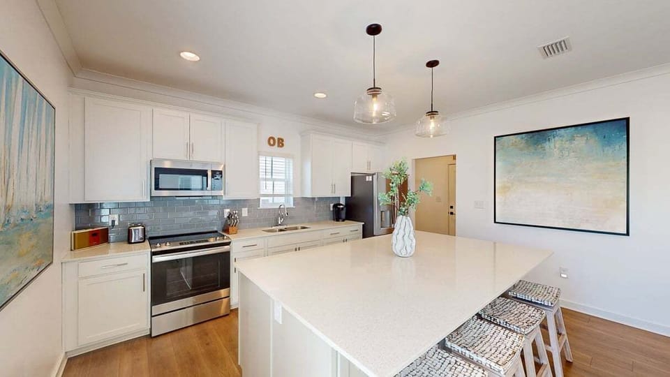 The well-equipped kitchen has everything you need to prepare your favorite meals, including a glass cooktop range, microwave, double sink, and a dishwasher.
