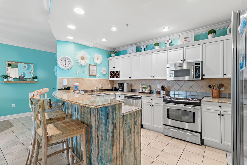 Fully equipped kitchen featuring granite countertops and stainless-steel appliances.
