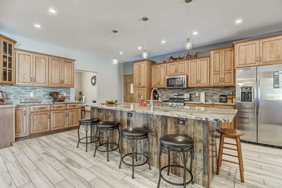 Fully stocked kitchen with modern appliances.