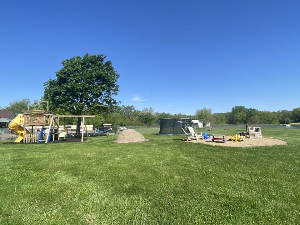 Inground trampoline, climbing rock, sandpit, picnic table, hammock, playground