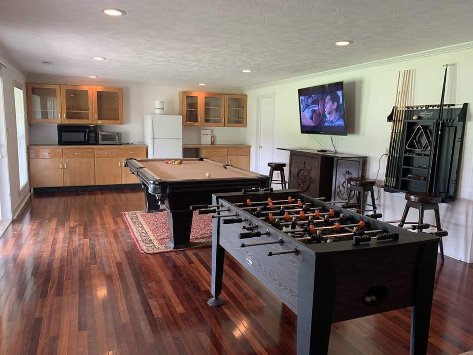 Foosball and pool table on lower level, kitchenette, XBox, smart tvs