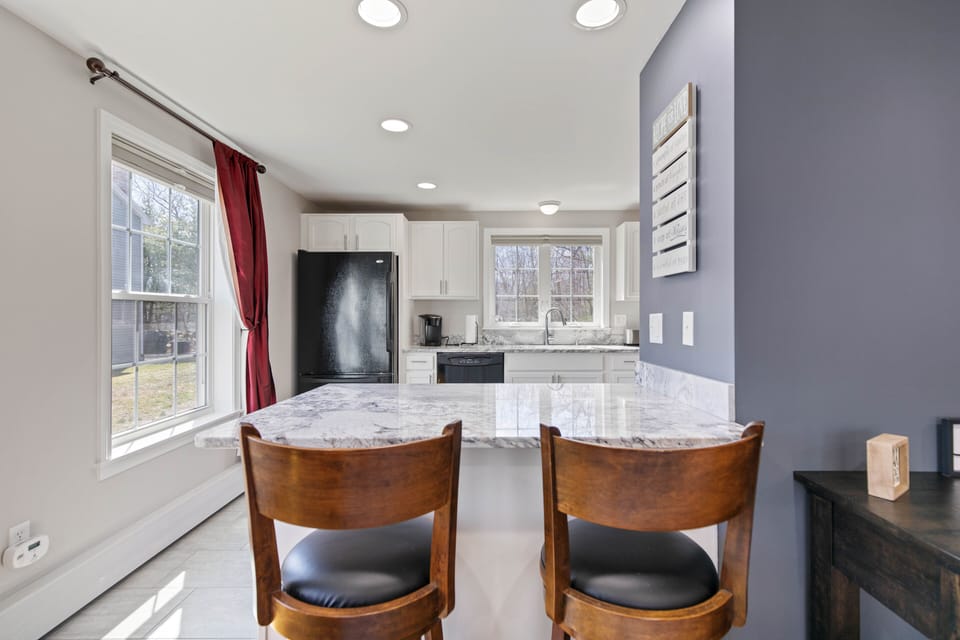 Fully stocked kitchen with granite counters and tiled floors, and peninsula