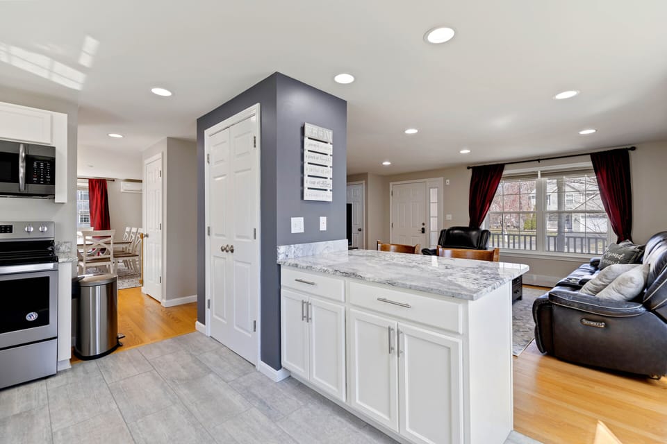 Fully stocked kitchen with granite counters and tiled floors, and peninsula