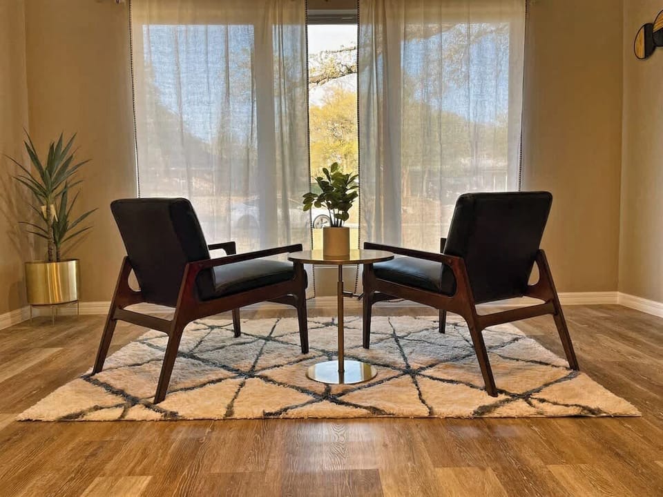 Reading nook looking out onto the front lawn through beautiful picture windows.