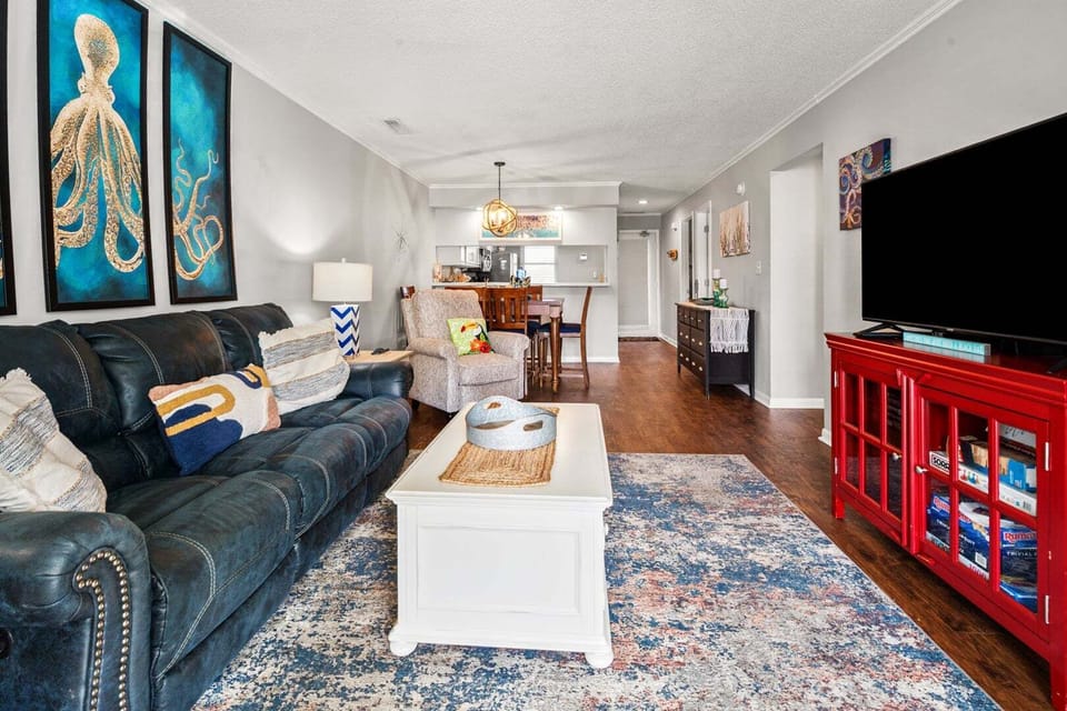 Sofa, coffee table and coastal wall art in the living room at Sandwedge 206, Ocean Drive, North Myrtle Beach