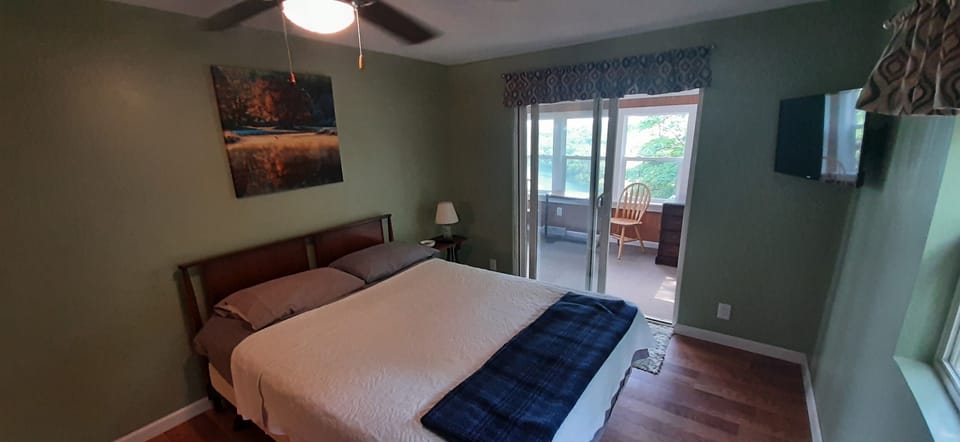 Master bedroom with access to 3 season room with sitting and study area. 